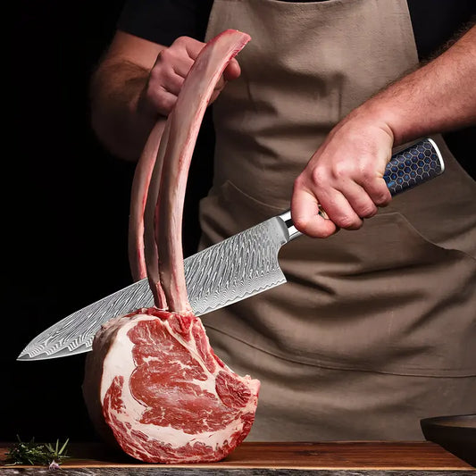 Le Gyuto Chef Impérial utilisé pour trancher une côte de bœuf crue, illustrant la puissance de coupe et la précision de la lame.