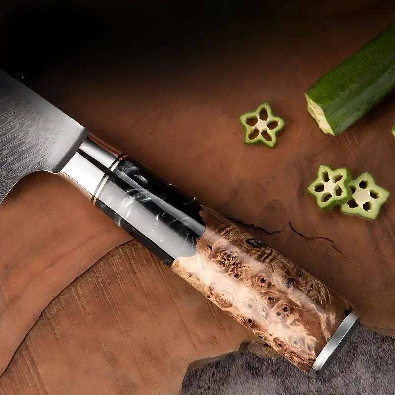 Gros plan sur le manche du Nakiri Essence de Tsubaki en bois stabilisé clairposé sur planche rustique.