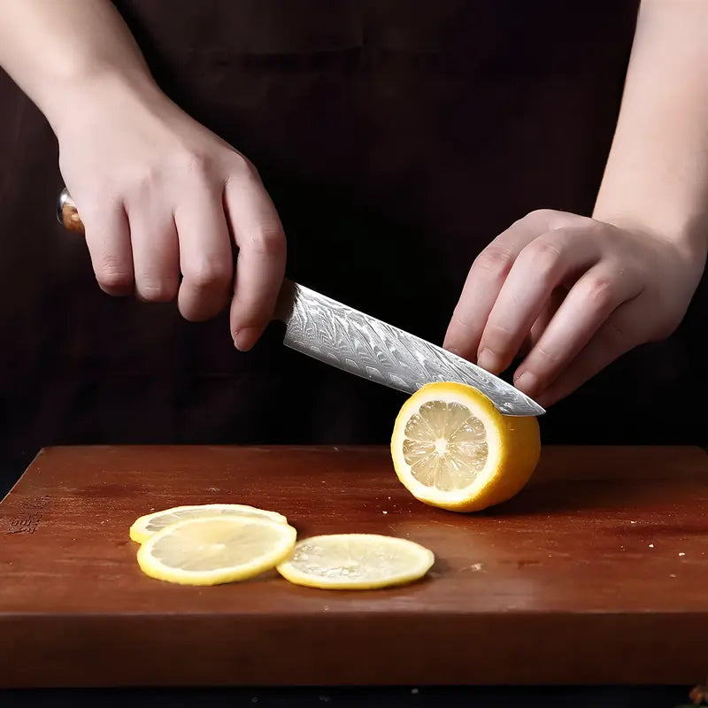 Le couteau d’office Ciel de Nara utilisé pour trancher un citron en rondelles, illustrant son tranchant précis.