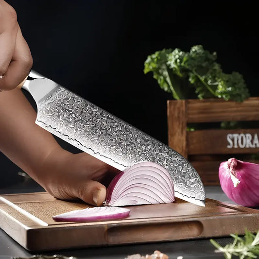 Découpe d’un oignon rouge avec un Santoku moderne en acier damas, sur planche en bois.