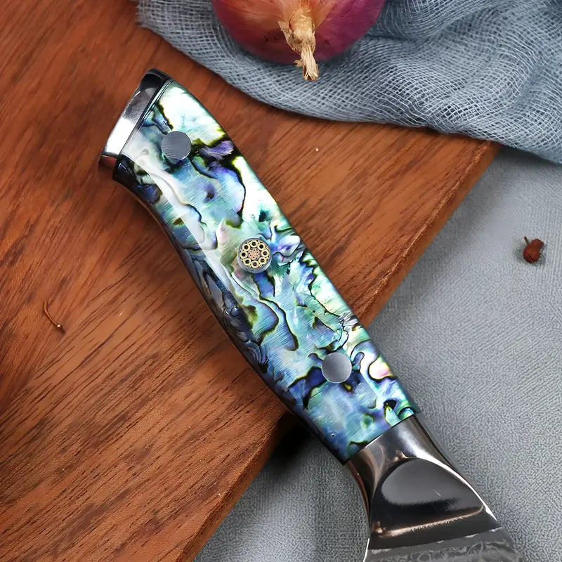 Vue rapprochée du manche du Santoku, avec ses reflets bleus et sa finition soignée.